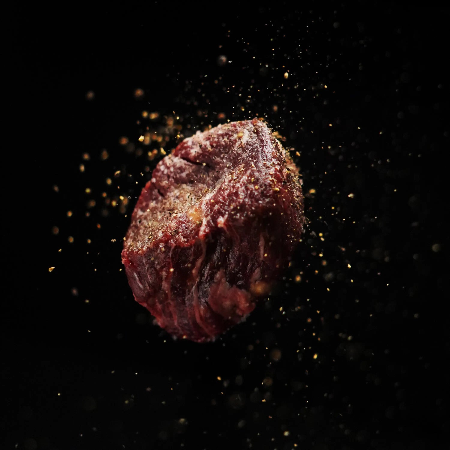 raw steak on dark surface