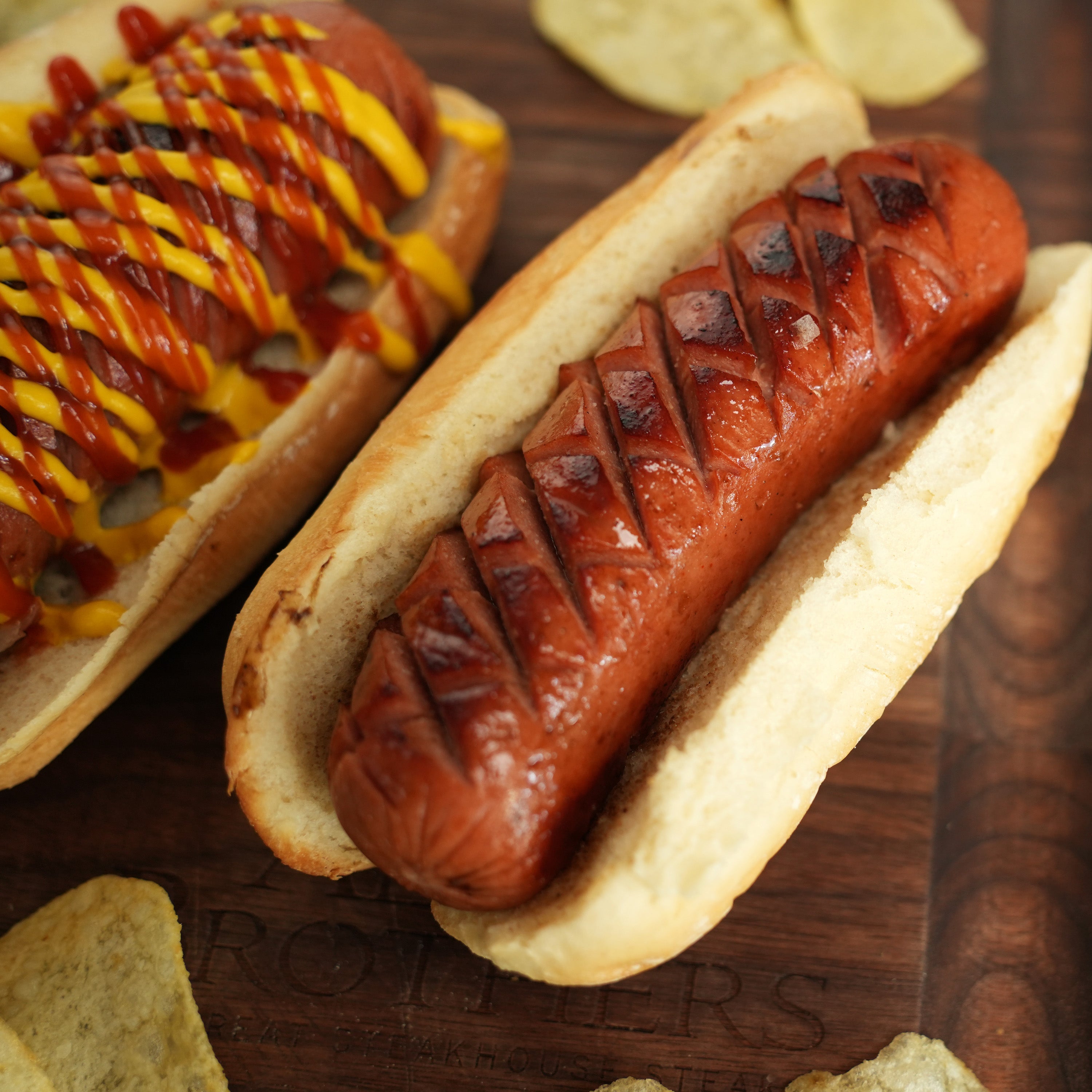 cooked hot dog in bun on wood board
