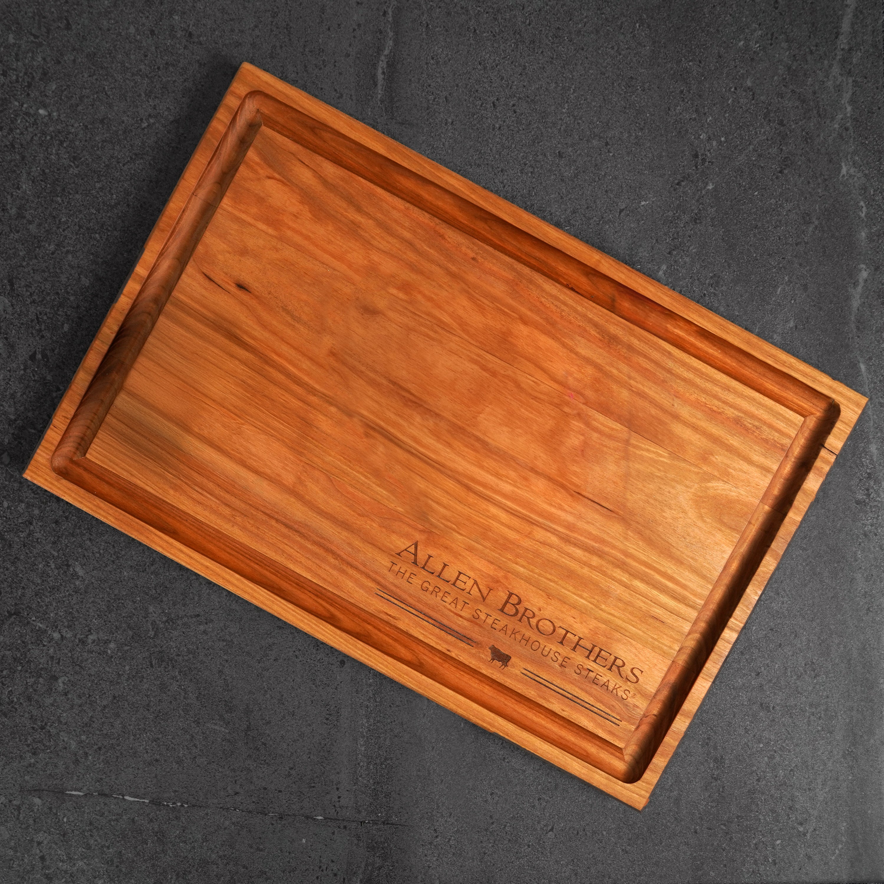 wood board with logo on dark surface