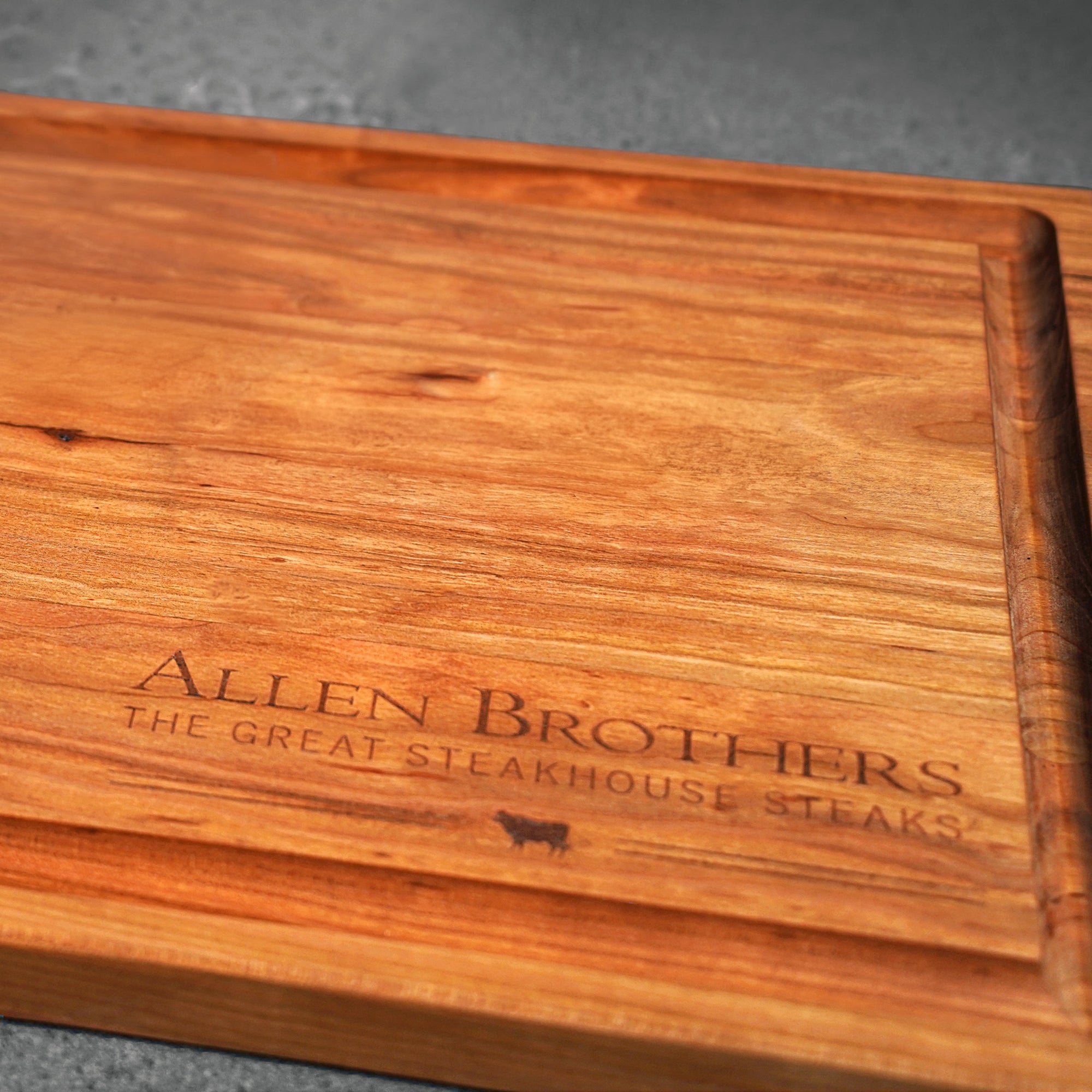 wood board with logo on dark surface