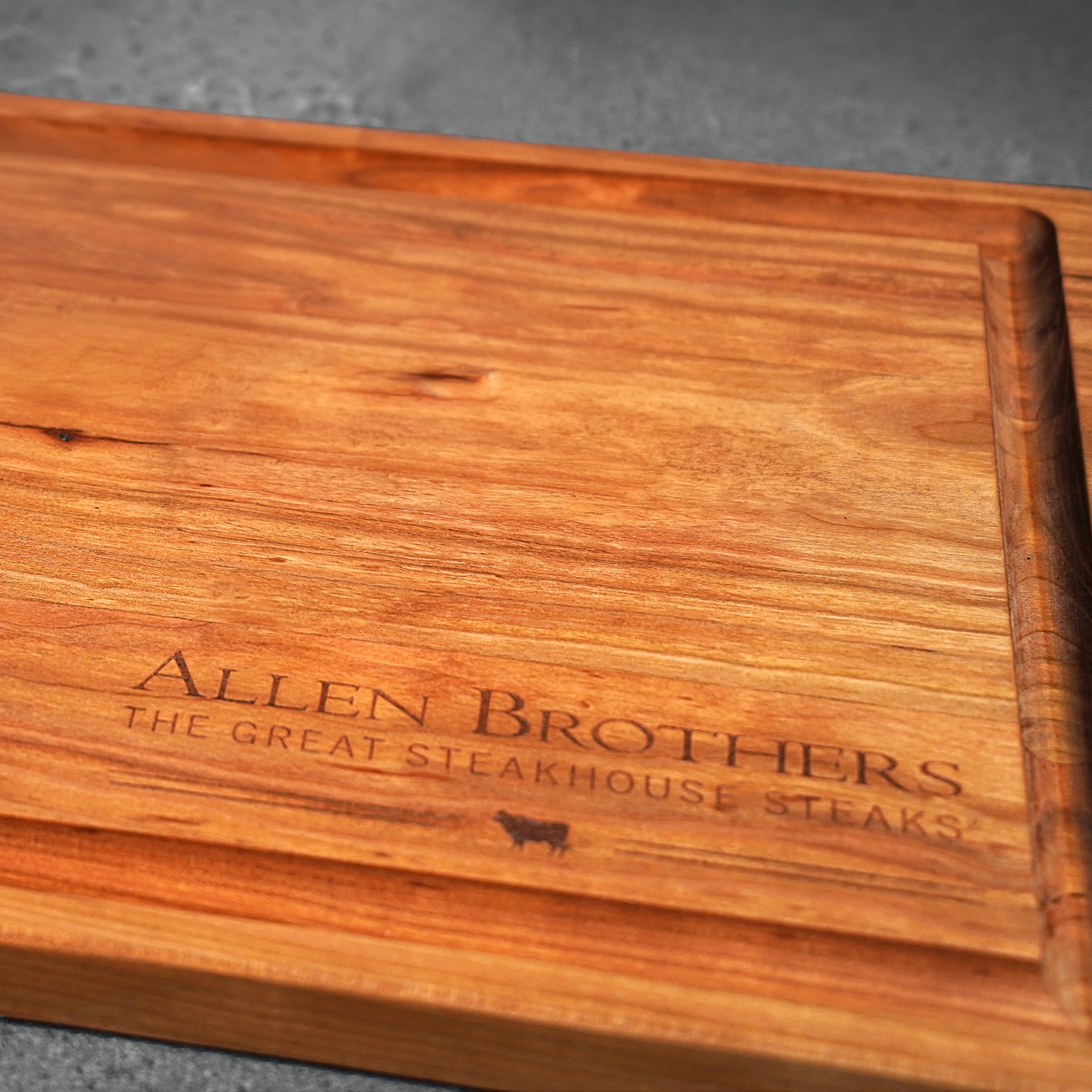 wood board with logo on dark surface