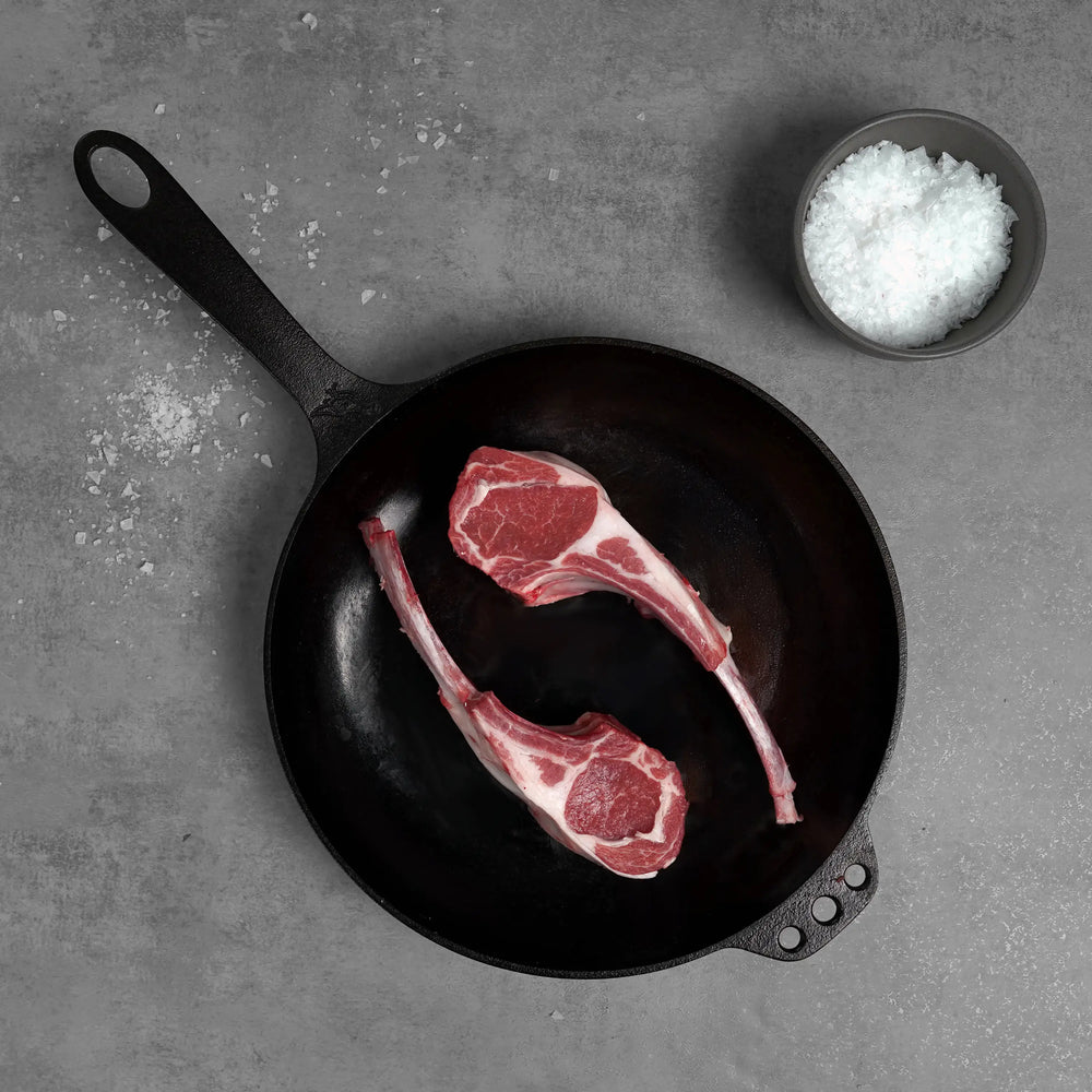 Allen Brothers Domestic All Natural Double Cut Lamb Chop raw on black pan