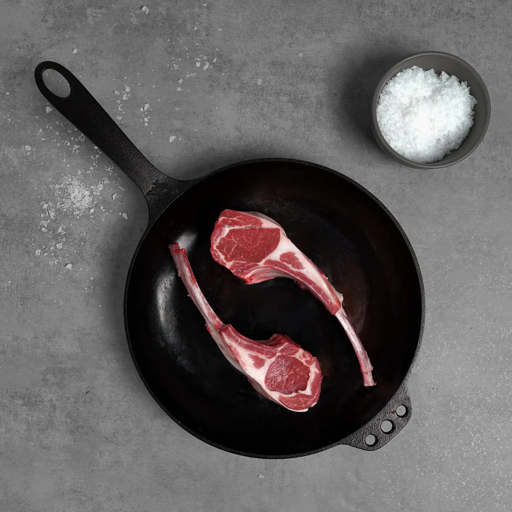 Allen Brothers Domestic All Natural Double Cut Lamb Chop raw on black pan