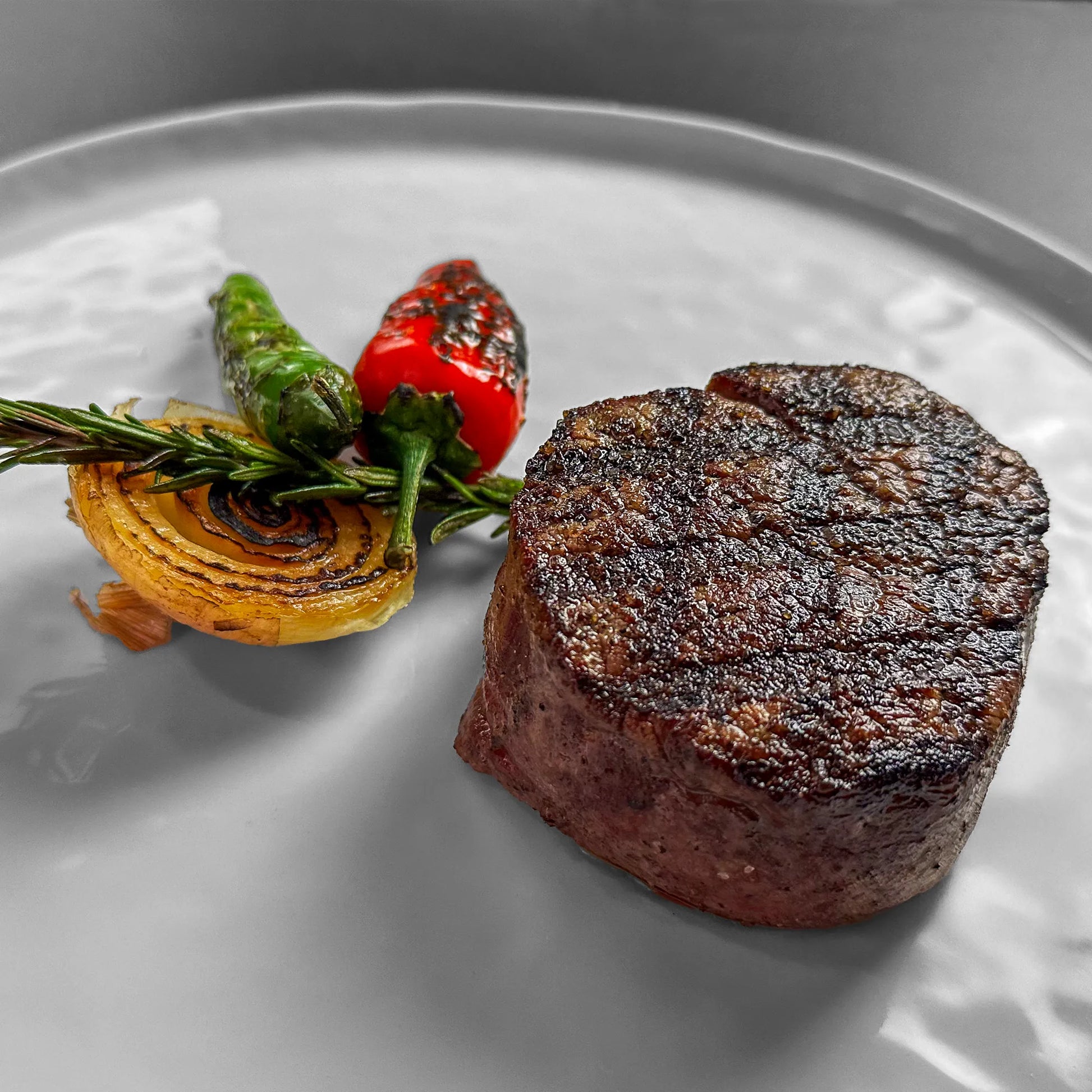 Close Up image of cooked filet on White Plate