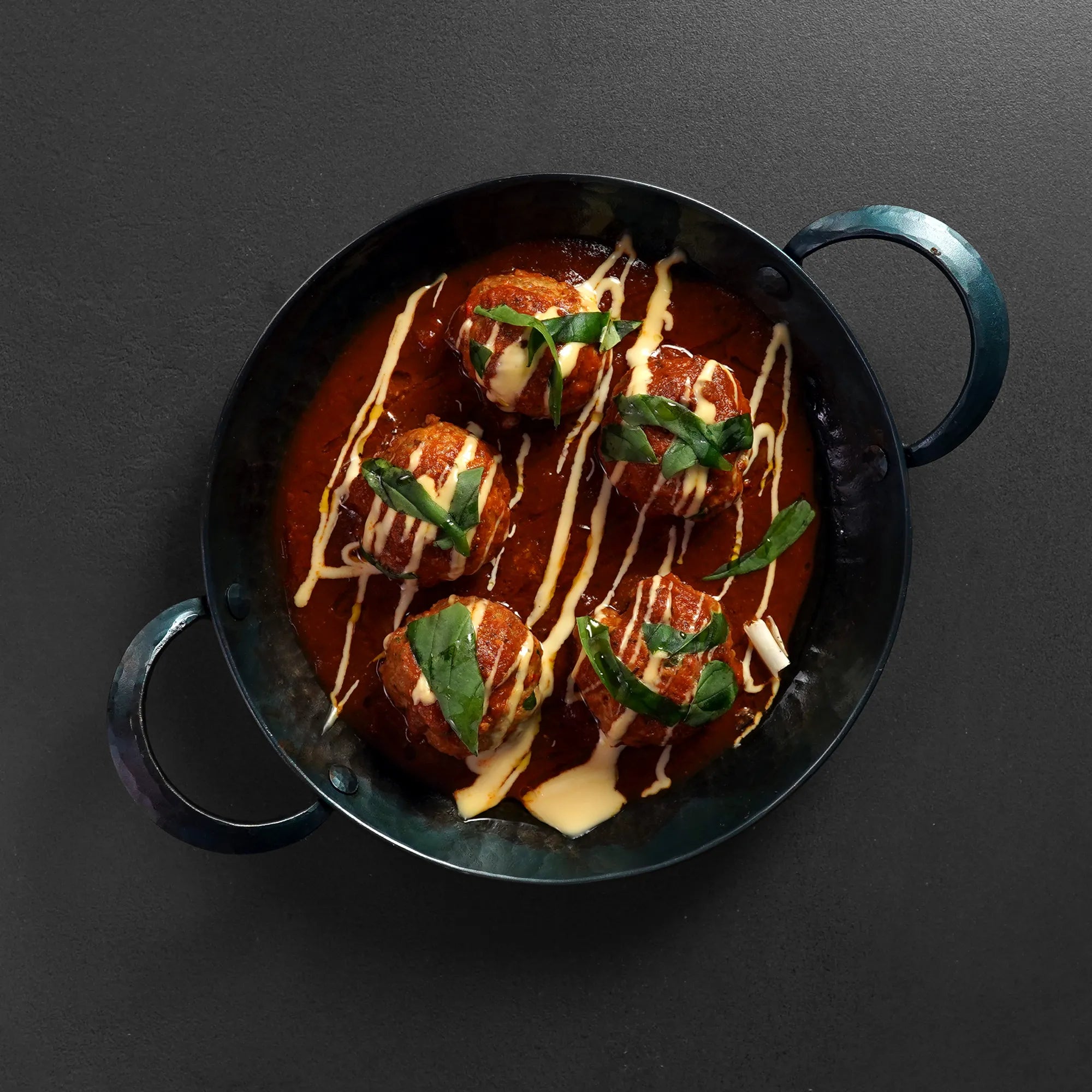 Cooked Meatballs in pan on cement
