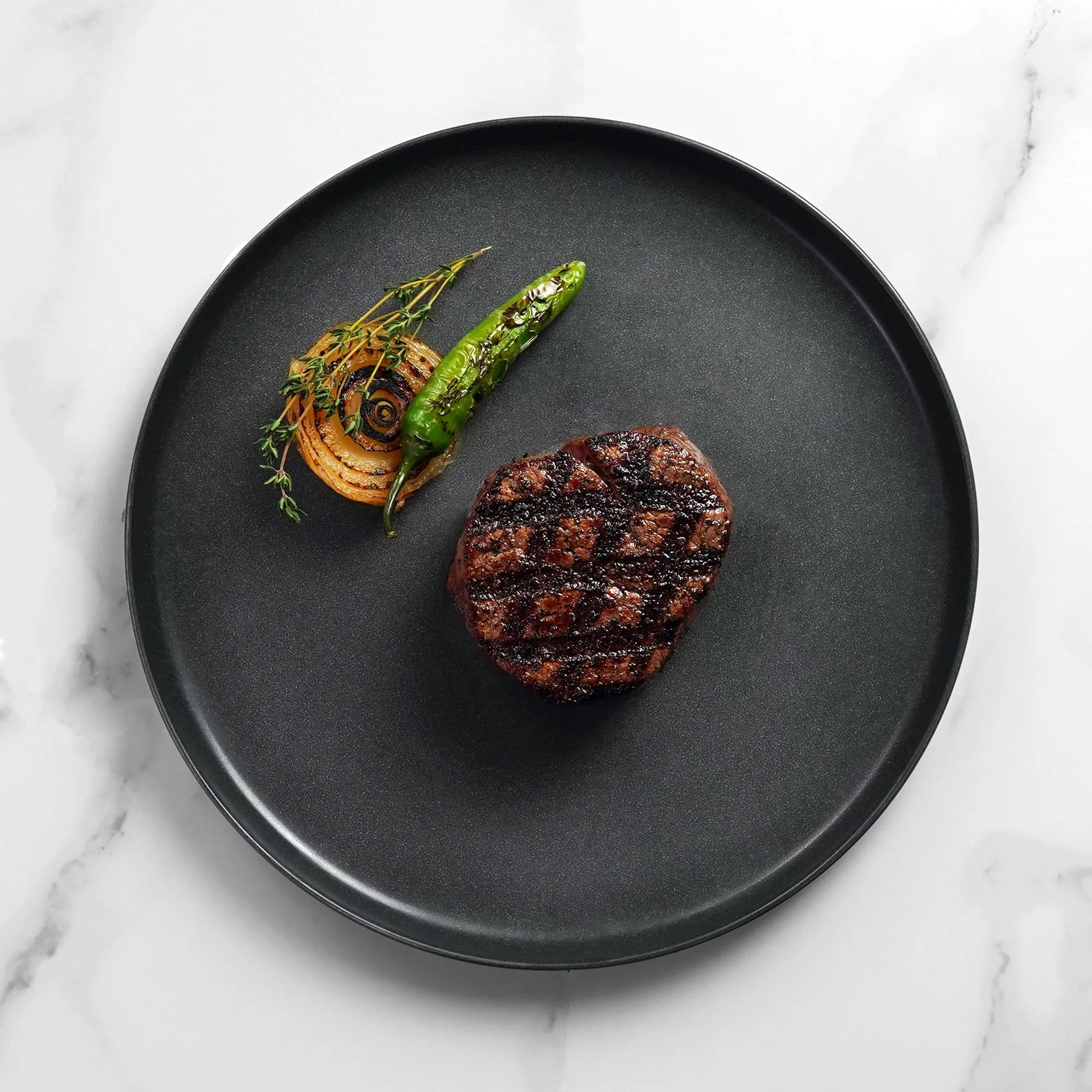 Close Up image of cooked filet on white marble