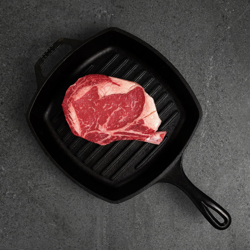 Raw Cowboy Steak In Pan