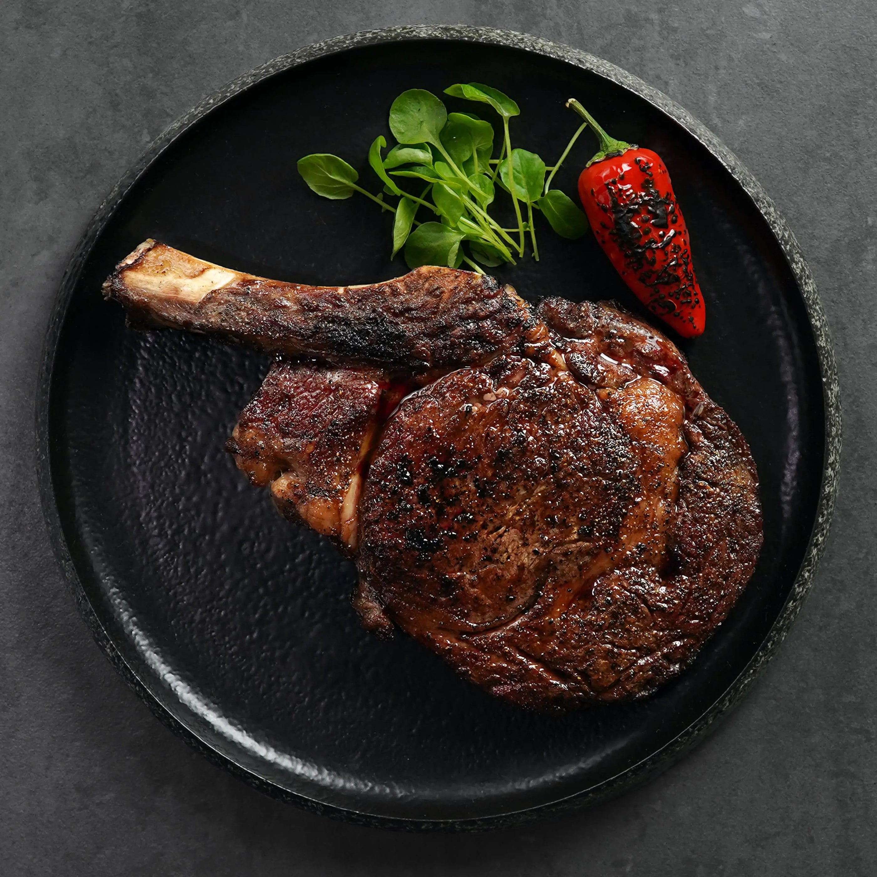 Cooked Frenched Ribeye on Stone Plate