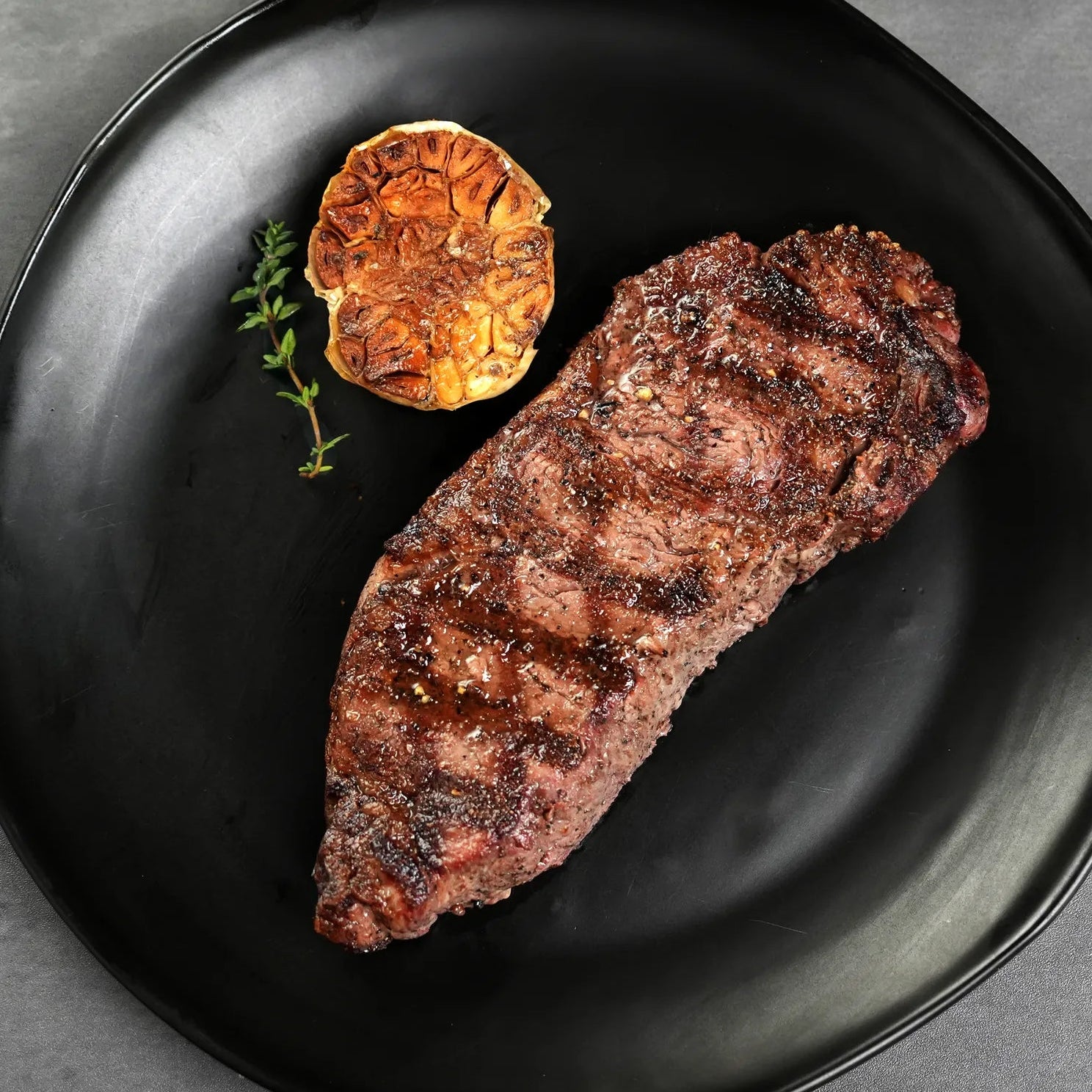 Cooked BNLS Strip on Black Plate