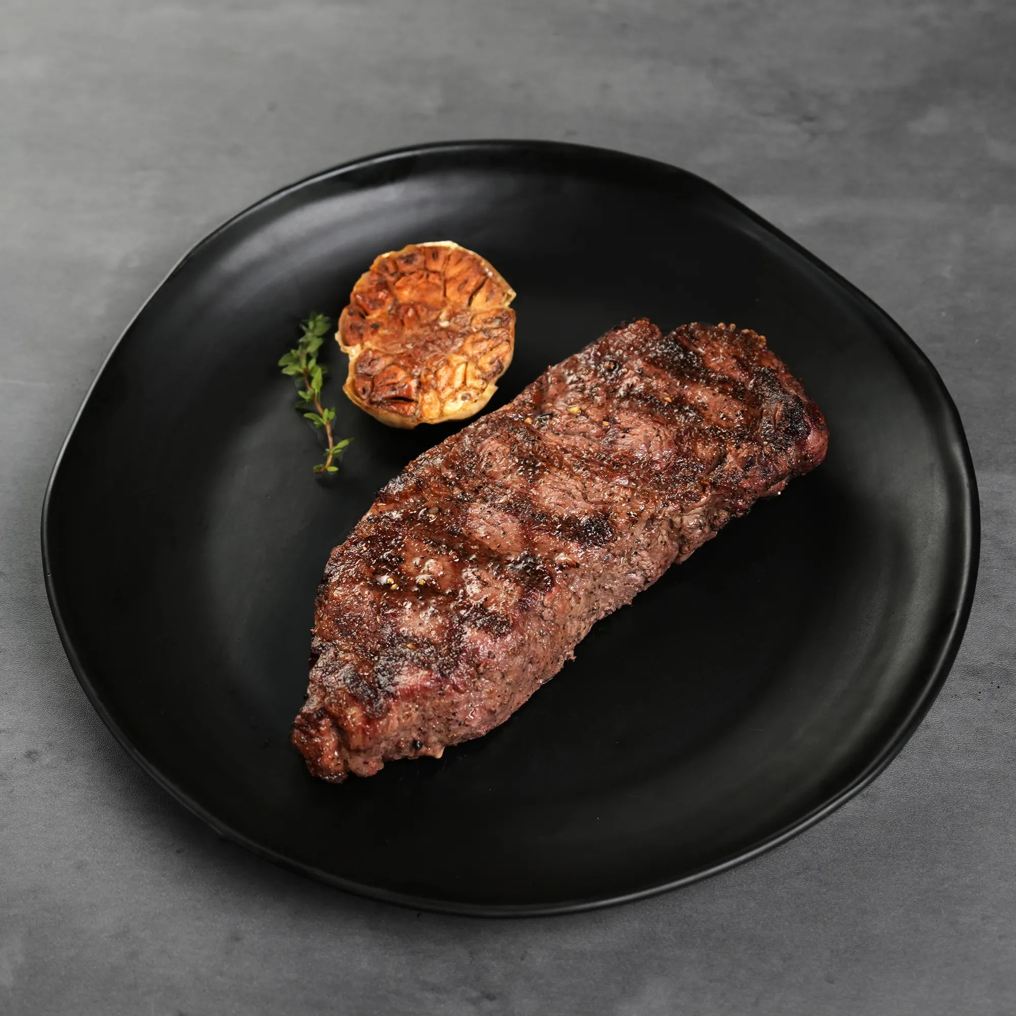 Cooked BNLS Strip on Black Plate