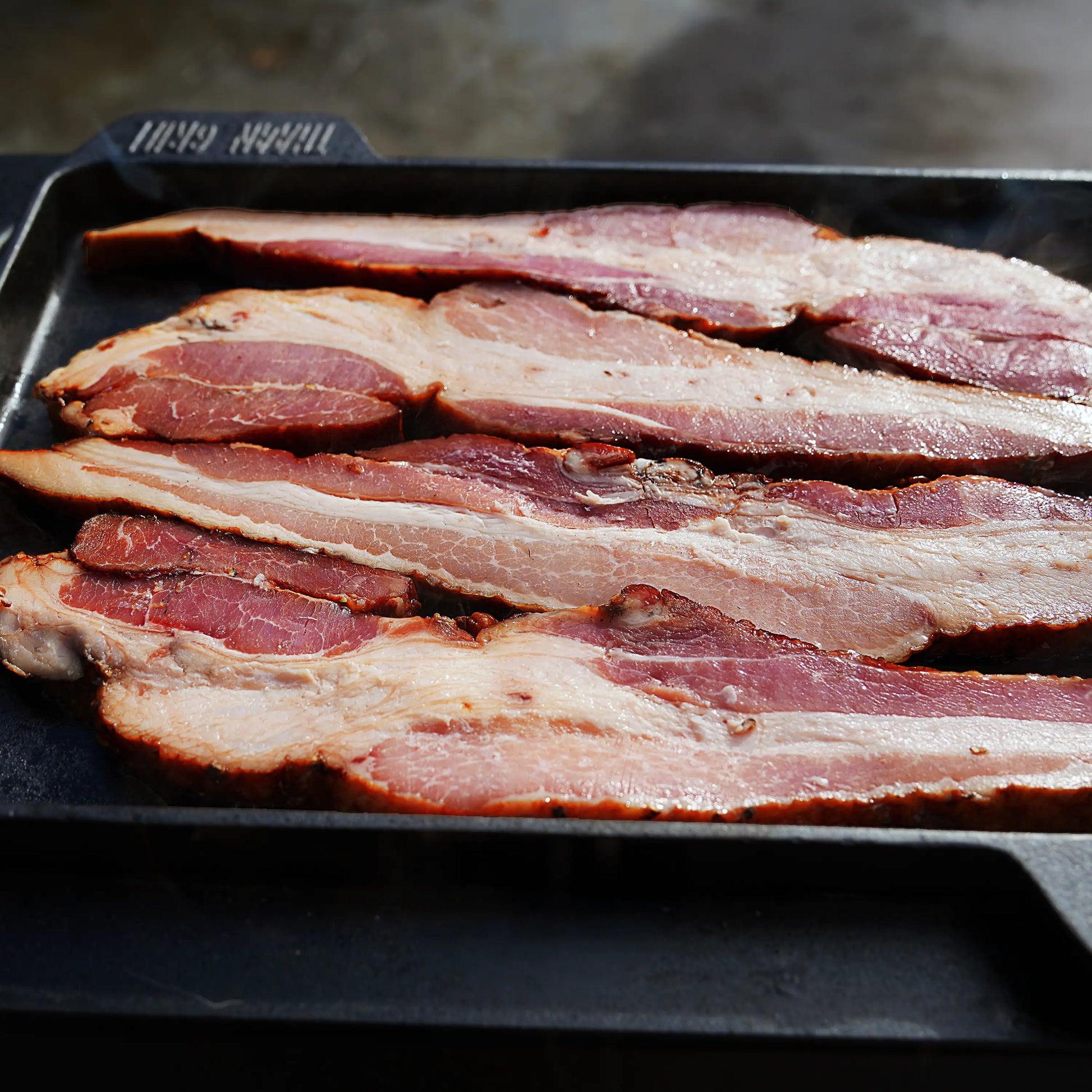 Bacon cooking on blackstone