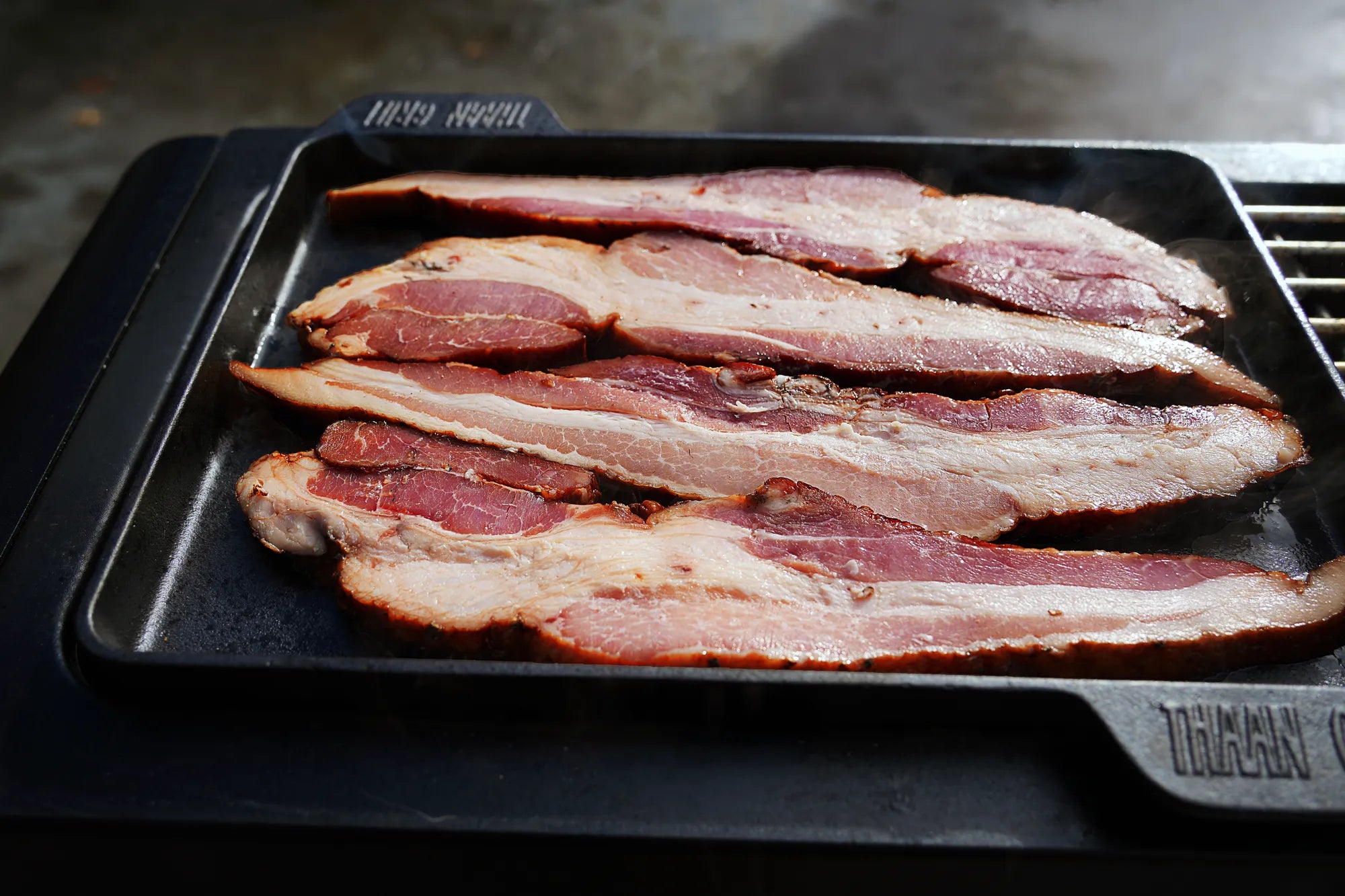 Bacon cooking on Black Stone