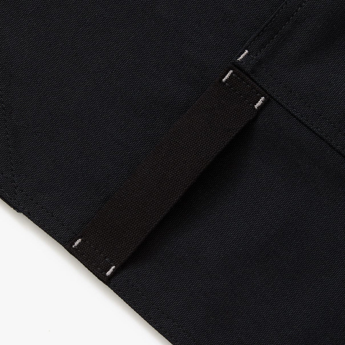 Black crossback apron strap end with stitched seam