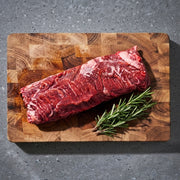 Westholme Australian Wagyu Hanger Steak on wooden board with rosemary sprig, showcasing its tender texture and intense flavor, ideal for high-heat searing.