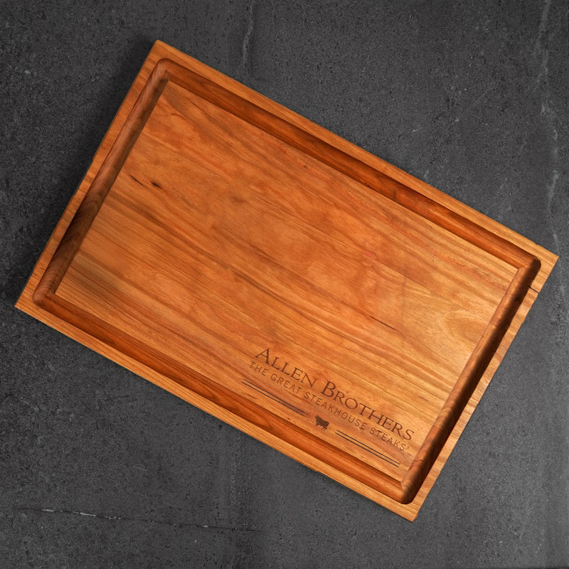 Father's Day Gift Box: Rectangular wooden serving board with Allen Brothers logo, ideal for presenting premium strip steaks and ribeyes, enhancing kitchen or backyard dining.