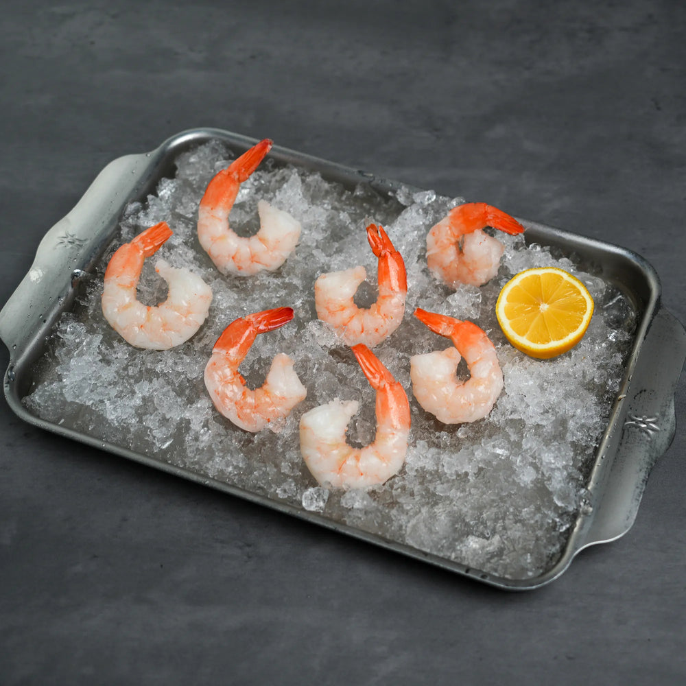 Foley Cooked Shrimp in a tray of ice with a  sliced lemon