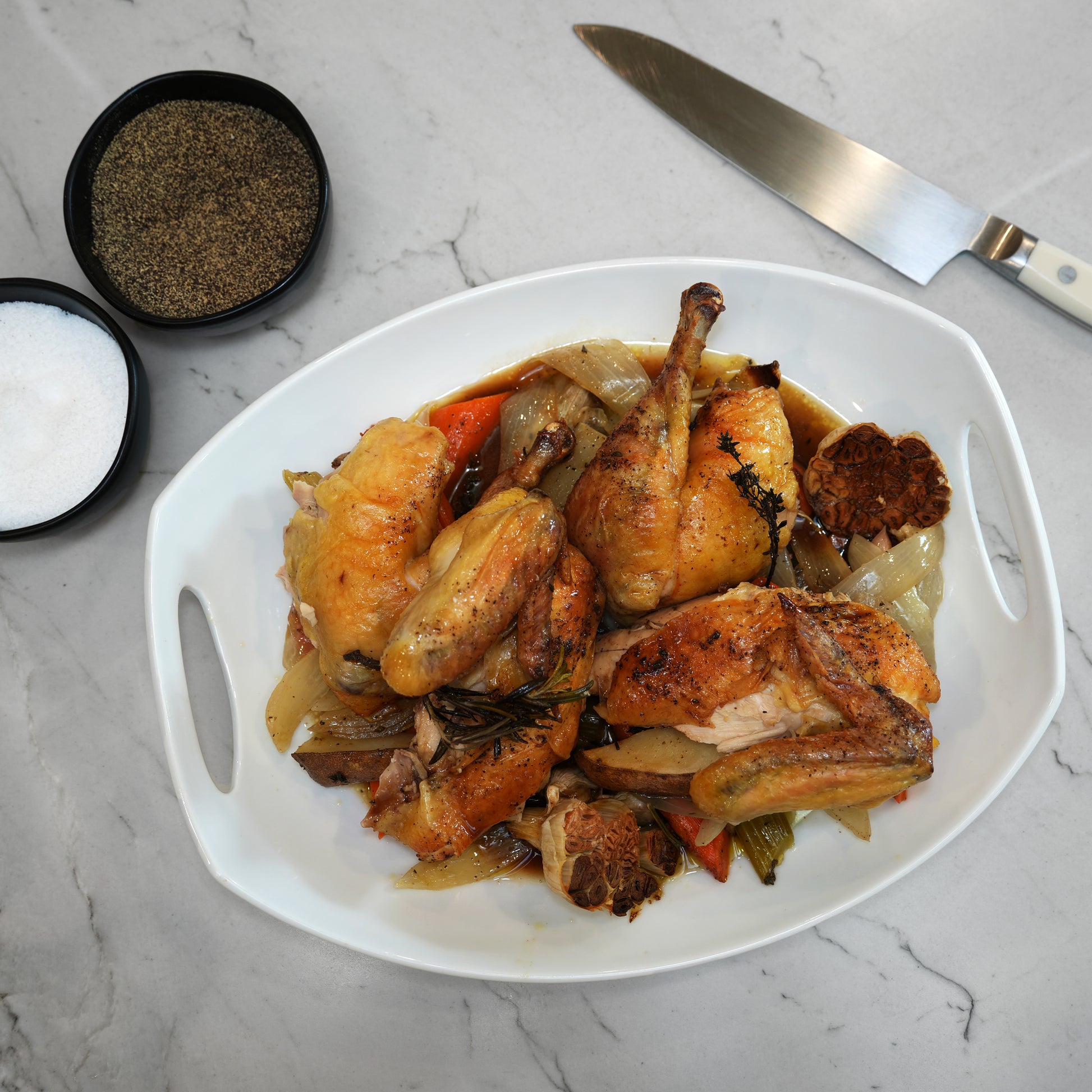 LaBelle Patrimoine Whole Chicken Cooked and broken down in white serving bowl on a white marble counter top