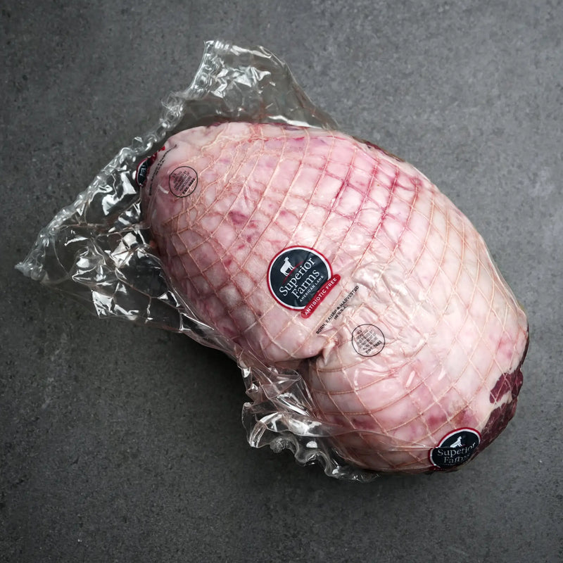 Vacuum-sealed Domestic All Natural Boneless Leg of Lamb Roast in plastic packaging with Superior Farms American Lamb – Antibiotic Free label, netted and ready to cook.
