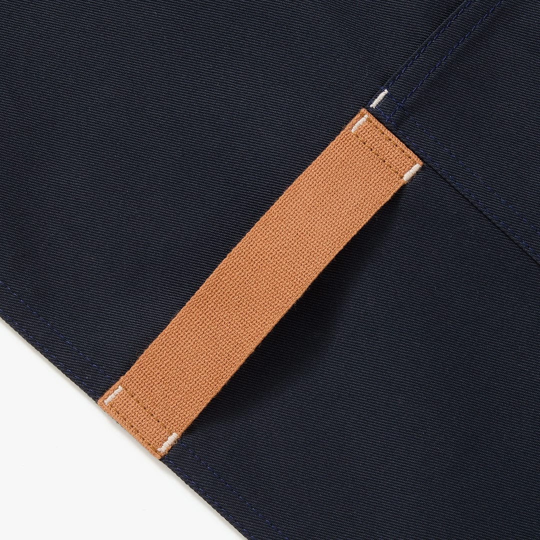 Midnight blue apron strap with tan webbing and stitched edge detail