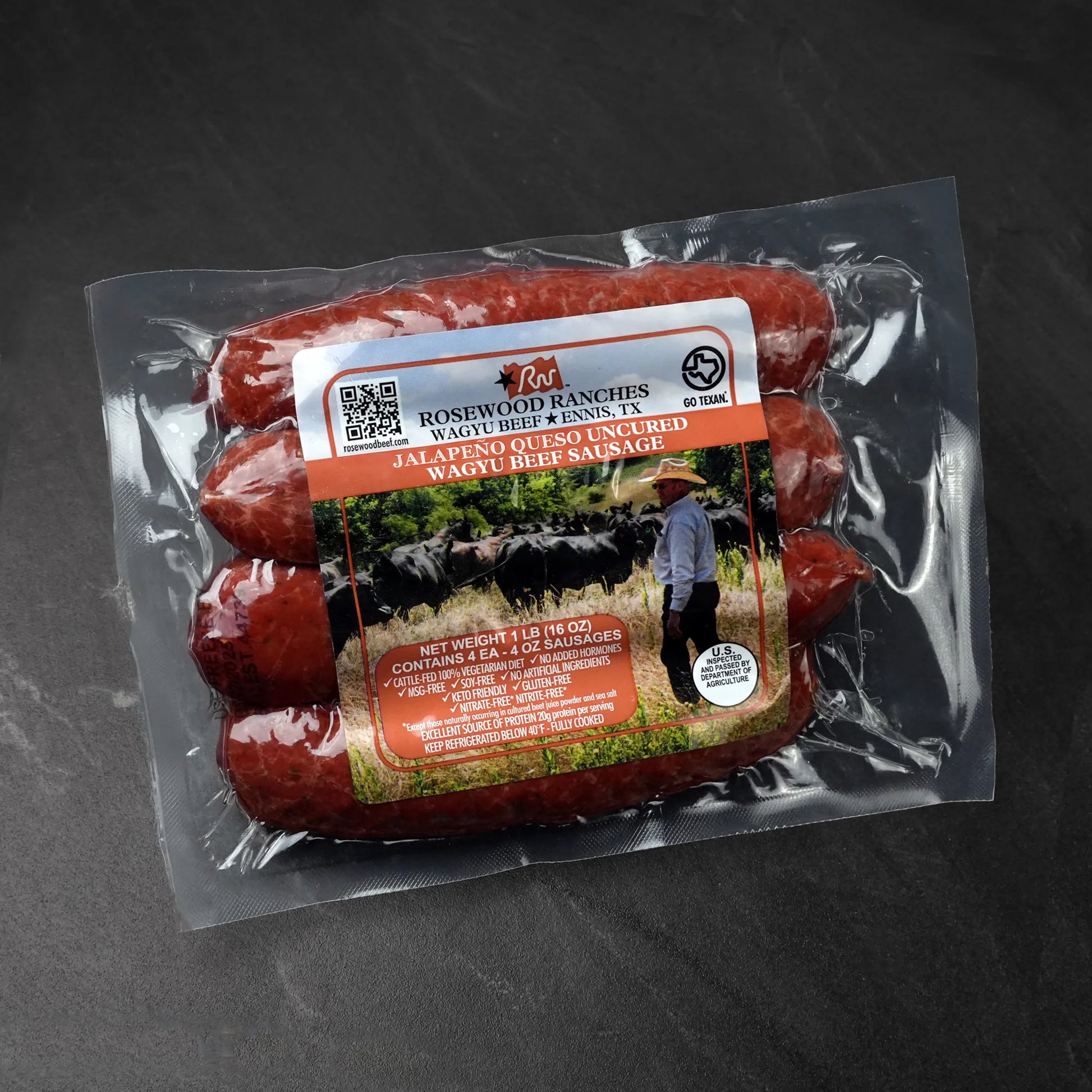 Rosewood Texas Wagyu Jalapeño Queso Sausage pack, featuring three uncured Wagyu beef sausages with White Cheddar, labeled with “no added hormones,” “MSG-free,” USDA inspected.