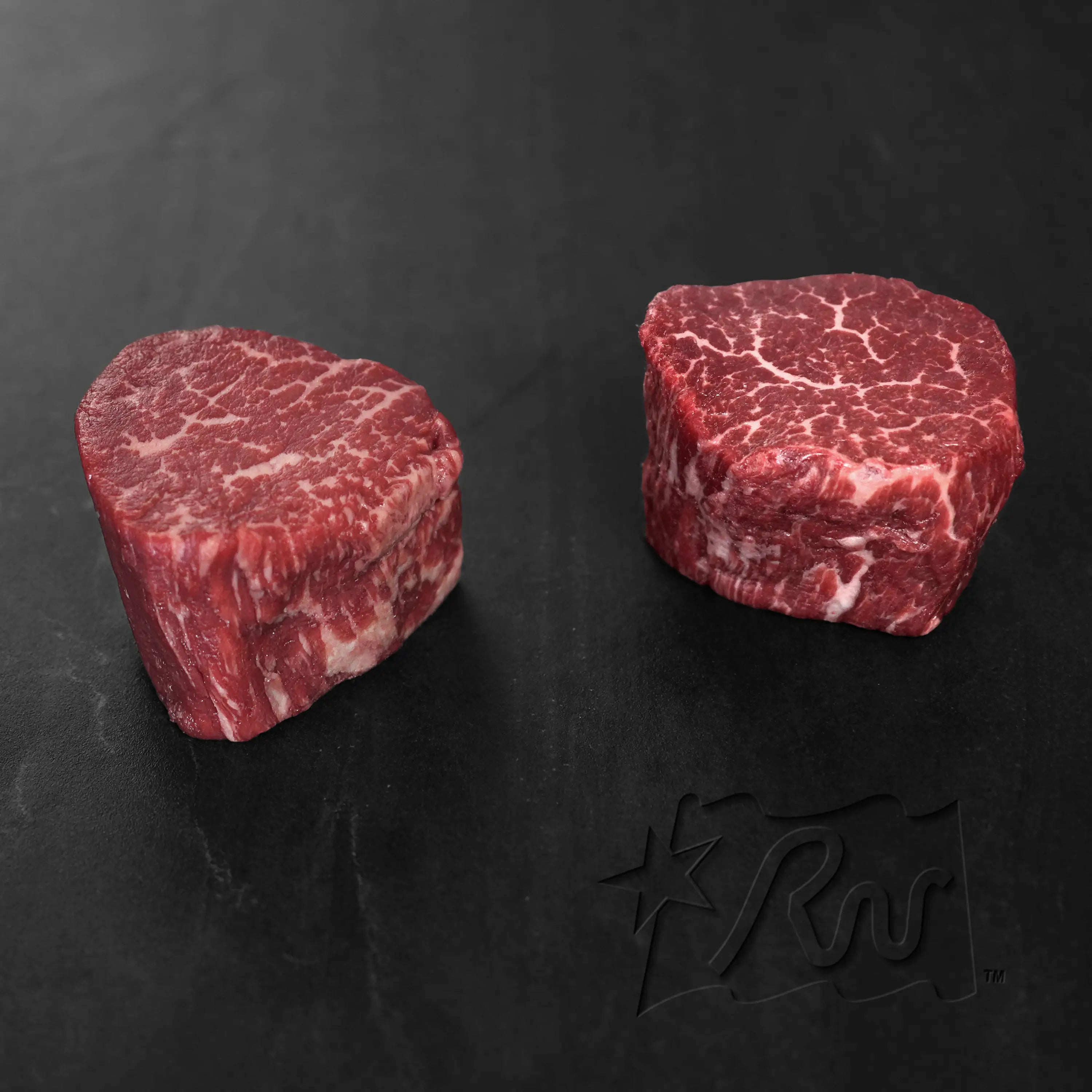 Rosewood Texas Wagyu Filet Mignon Steak, featuring two raw medallions with deep red color and intricate marbling, showcasing premium American Wagyu quality.