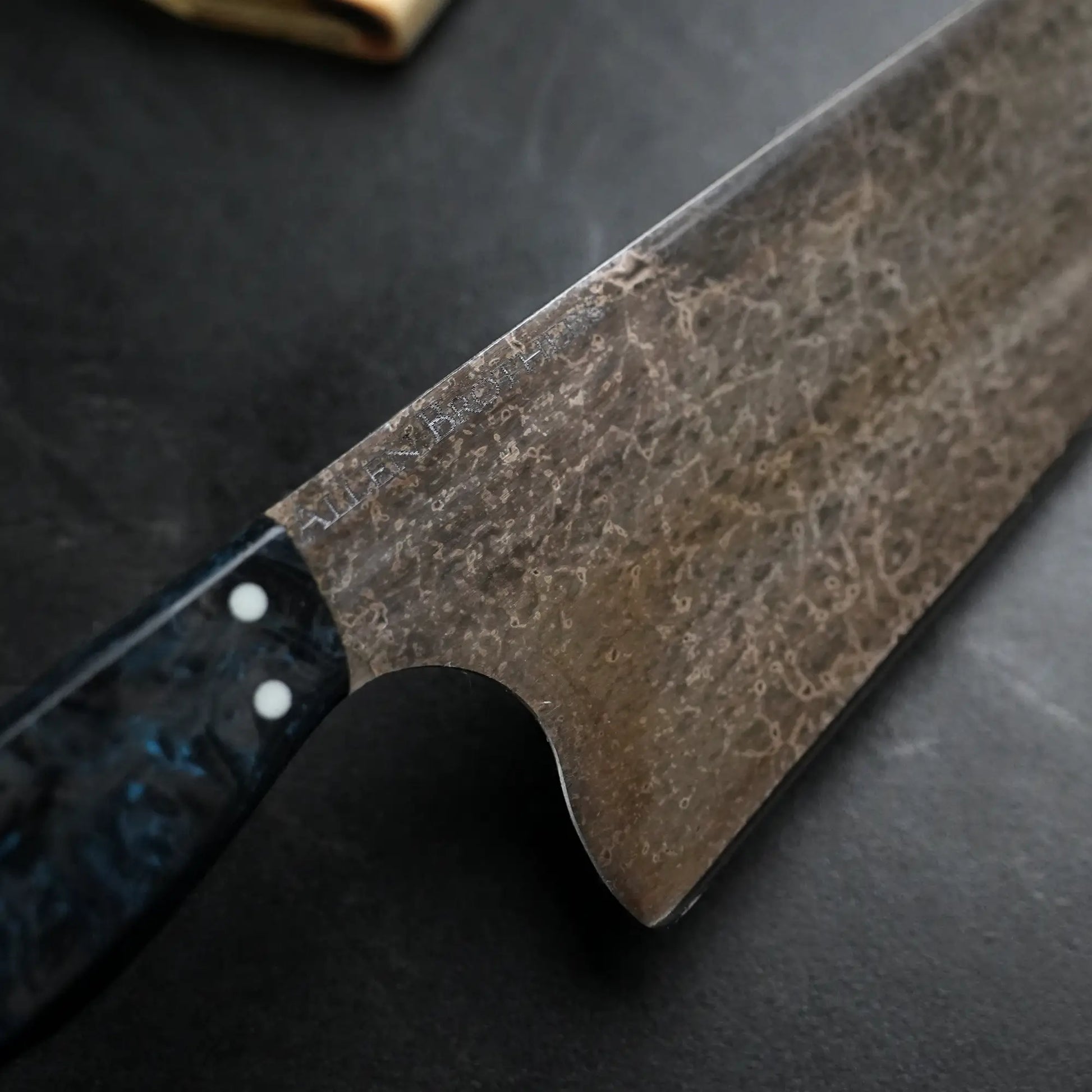 TH Blades Handcrafted 8 Chef Knife, featuring a patterned steel blade and riveted handle, perfect for serious cooks seeking durability and artistry.