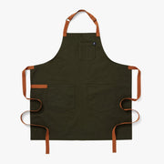 Olive green apron with front pockets and tan-orange adjustable neck straps