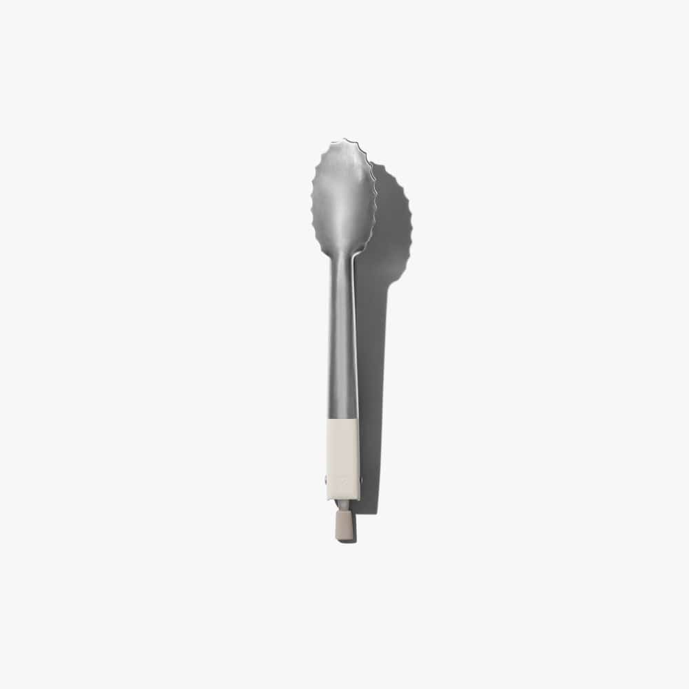 Stainless steel tongs with scalloped end and white silicone handle