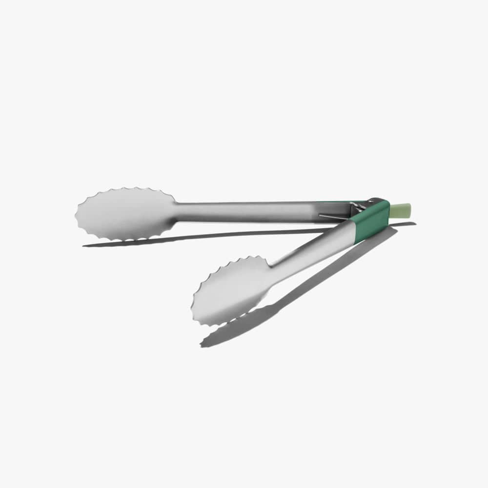 Stainless steel tongs with serrated scalloped tips and green handle, side view