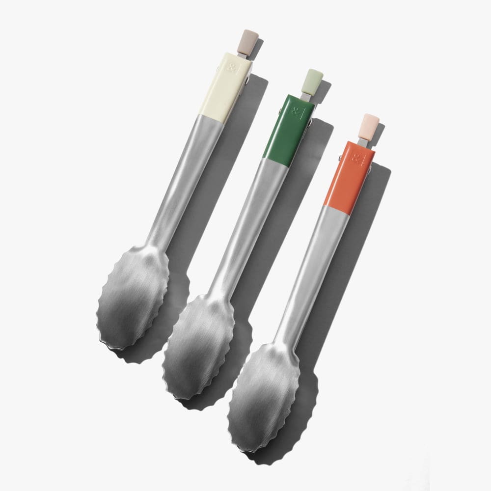 Assorted stainless steel tongs with light, shiso green, and orange handles
