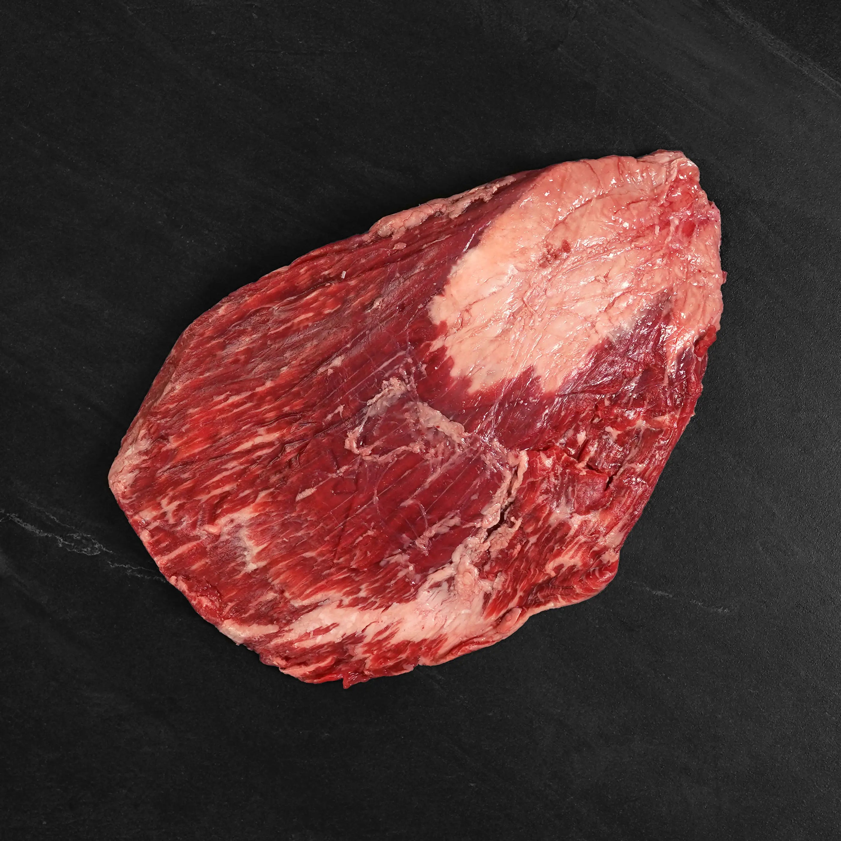 Rosewood Ranches Texas Wagyu Flank Steak, a large raw beef slab with white fat streaks, ideal for marinades, perfect for fajitas or stir-fries.