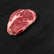 Westholme Australian Wagyu Steak Combo features a thick-cut, highly marbled rib-eye steak, showcasing fine white fat streaks for premium tenderness and flavor.