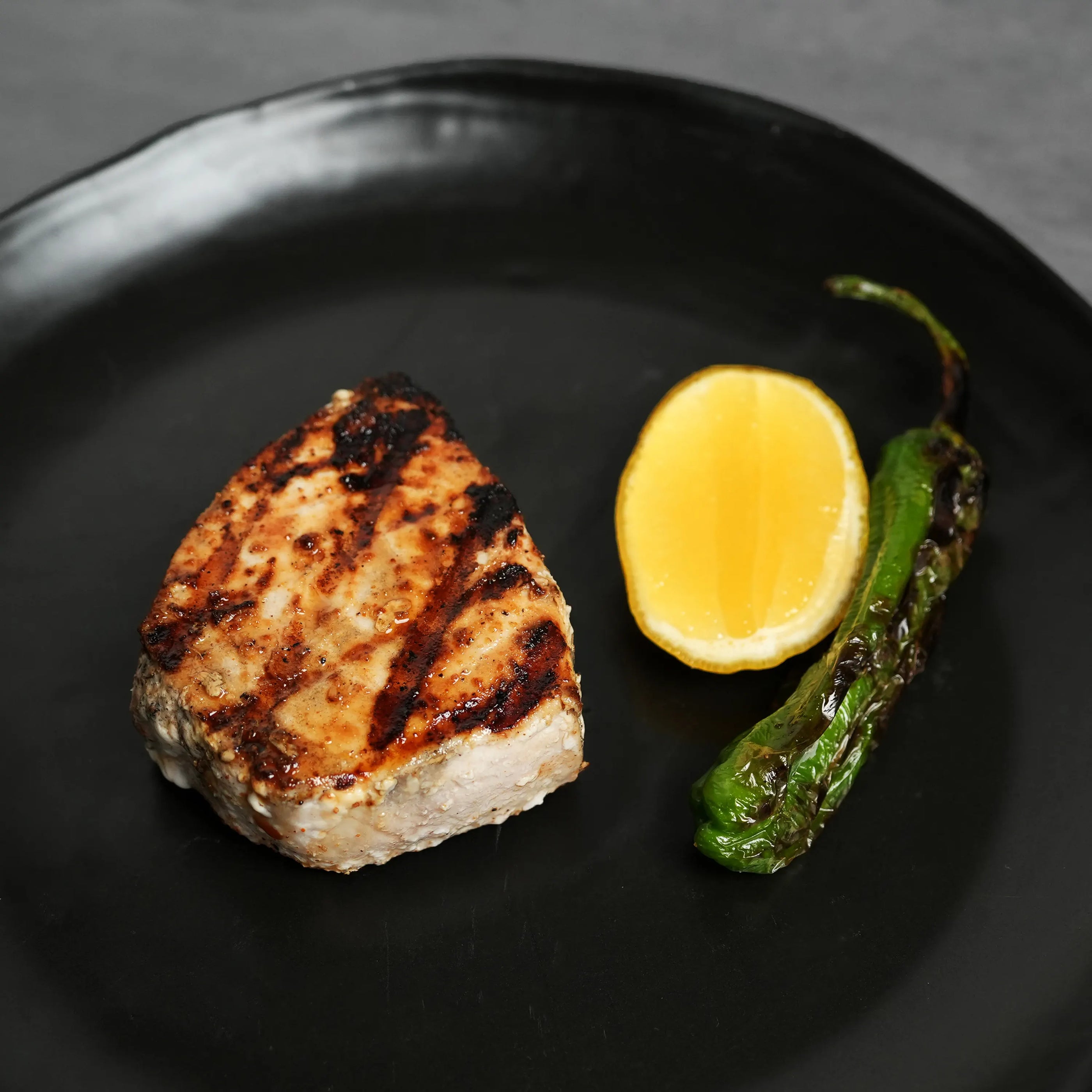 Swordfish Filet on Black Plate