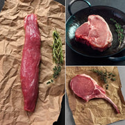 Heritage Duroc Pork Tasting Combo: raw beef tenderloin, boneless steak, and bone-in rib-eye with rosemary and thyme, ready for cooking.